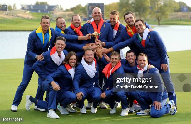 Thomas Bjorn of Denmark and captain of the victorious European Team pose with the Ryder Cup after their 17.5-10.5 win over the United States during...