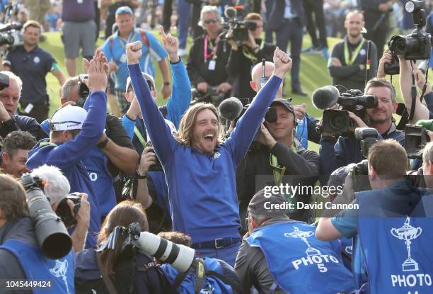 Tommy Fleetwood of England and the European Team is held aloft as he celebrates amongst a scrum of cameras after Europe's 17.5-10.5 win over the...