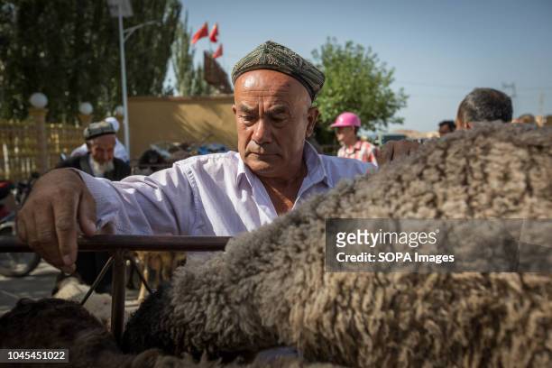 Local Uyghur man waits for customers at a livestock market in Kashgar city, northwestern Xinjiang Uyghur Autonomous Region in China. The Kashgar...