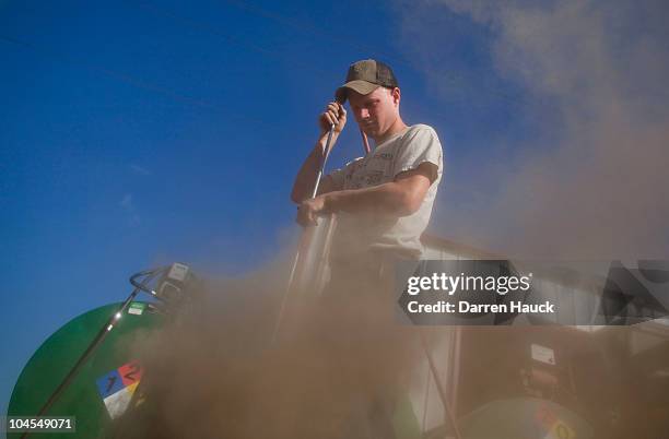 Rick Roden cleans out an air filter for a large tractor at the Rob-N-Cin farm on September 29, 2010 in West Bend, Wisconsin. The farm has roughly 400...