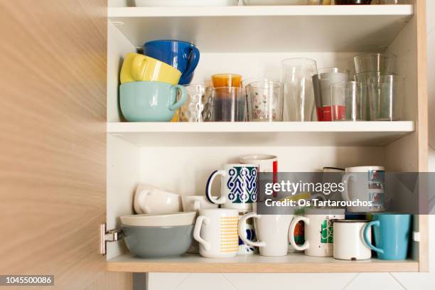 kitchen cabinet with mugs and glasses - armadietto da cucina foto e immagini stock