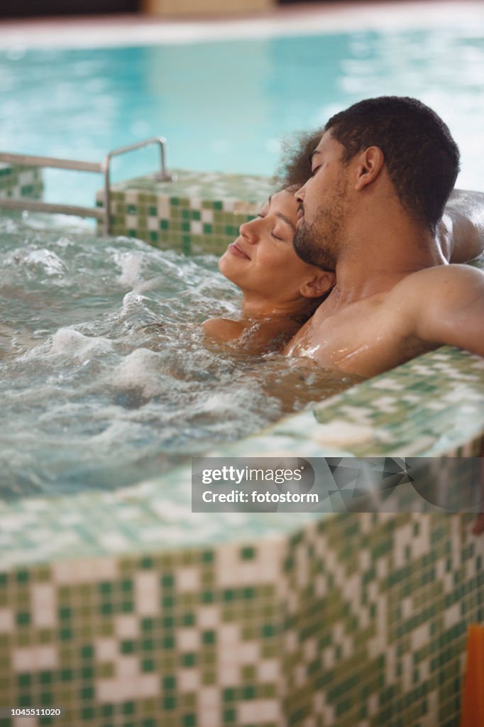Couple relaxing in a hot tub at spa