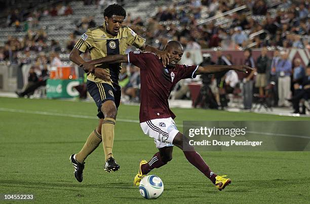 Omar Cummings of the Colorado Rapids tries to control the ball while Sheanon Williams of the Philadelphia Union defends at Dick's Sporting Goods Park...