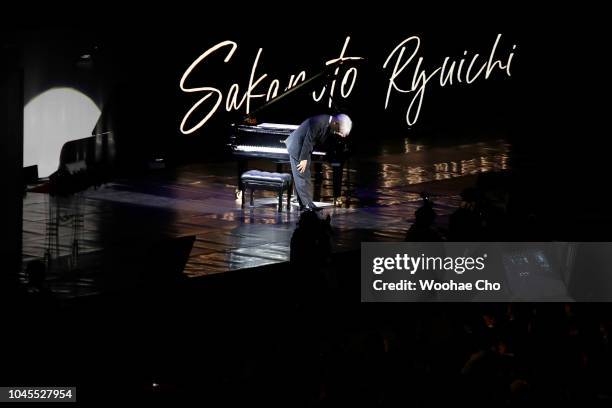 Japanese musician Ryuichi Sakamoto bows to the audience after playing the music he's composed for the screen plays during the Opening Ceremony of the...