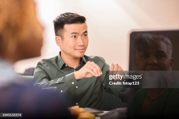 business man signing during team meeting. - american sign language stock pictures, royalty-free photos & images