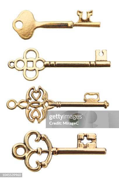 gold colored old keys - golden key stock-fotos und bilder