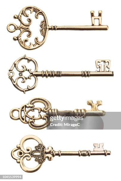 gold colored old keys - golden key stock-fotos und bilder