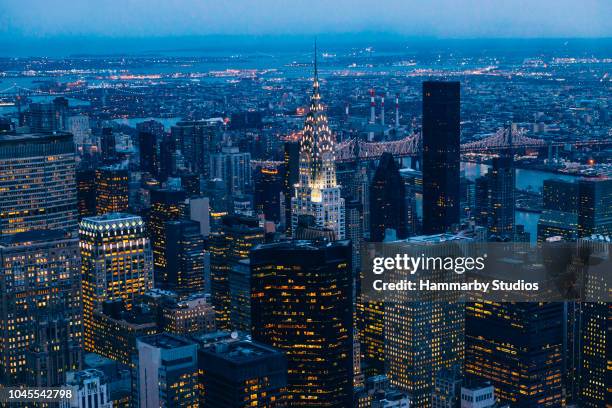 new york skyline through empire state building at dusk - chrysler building stock pictures, royalty-free photos & images