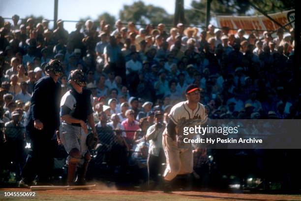 Eddie Mathews of the Milwaukee Braves runs towards first base after hitting the pitch during an MLB Spring Training game circa March, 1956 in...