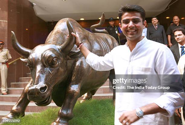 Union Minister of state for Communication and Information Technology Sachin Pilot poses for a photograph with the 'bull' at the Bombay Stock Exchange...