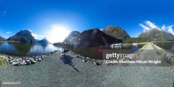 may 2017, milford sound national park, new zealand. a  360 view of a couple sitting and taking in their surroundings in milford sound and mitre peak. - 360 vr stock pictures, royalty-free photos & images