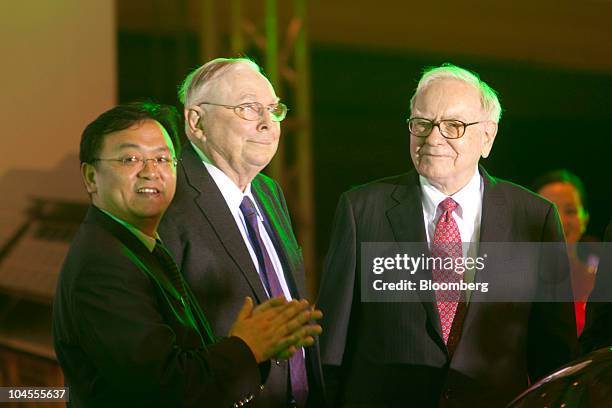 Wang Chuanfu, chairman of BYD Co., left, Charles Munger, vice chairman of Berkshire Hathaway Inc., center, and Warren Buffett, chairman of Berkshire...