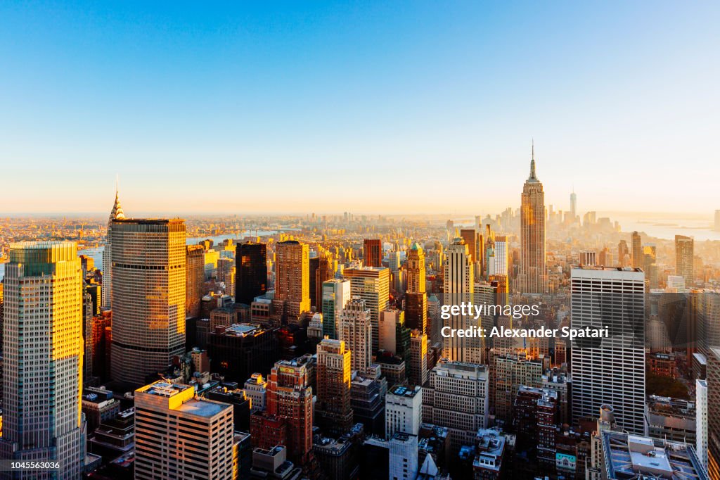 Helicopter aerial view of New York City skyline during sunset, NY, United States