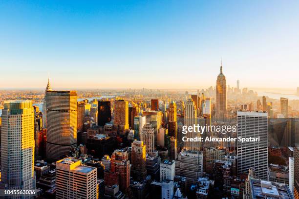 helicopter aerial view of new york city skyline during sunset, ny, united states - midtown manhattan stockfoto's en -beelden