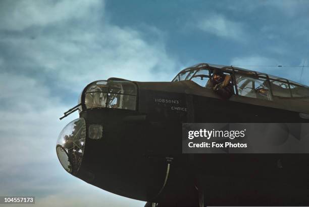 An RAF pilot looks out of the cockpit of his Lancaster Bomber, circa 1940.