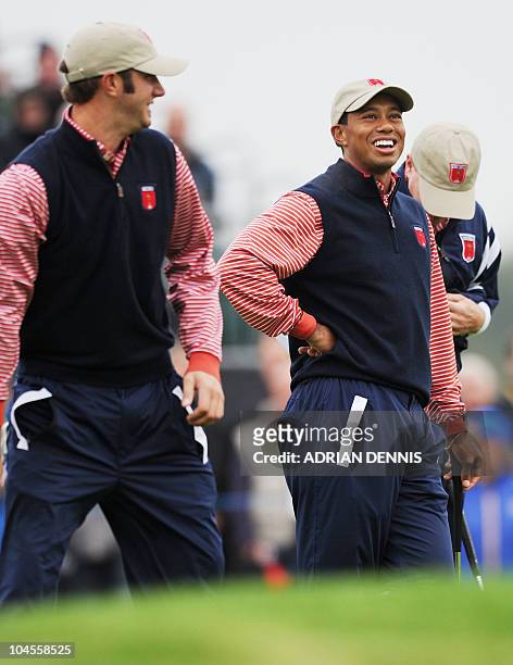 Ryder Cup player Tiger Woods laughs with team mate Dustin Johnson during a practice session at Celtic Manor golf course in Newport, Wales on...