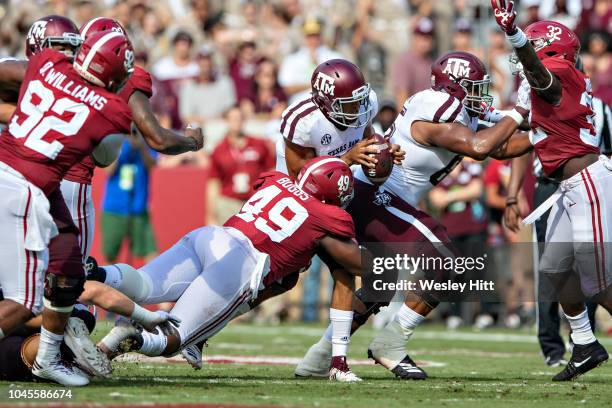 Kellen Mond of the Texas A&M Aggies is sacked by Isaiah Buggs of the Alabama Crimson Tide at Bryant-Denny Stadium on September 22, 2018 in...