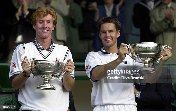 Mark Woodforde and Todd Woodbridge of Australia with the trophy after beating Paul Haarhuis of Holland and Sandon Stolle of Australia during the...