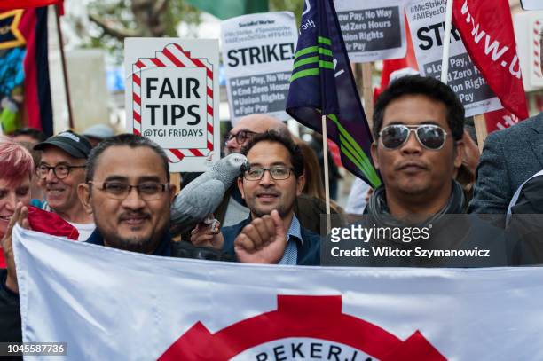 McDonald's, JD Wetherspoons, TGI Friday's and Uber Eats workers, trade unionists and campaigners gather in Leicester Square in London to protest...