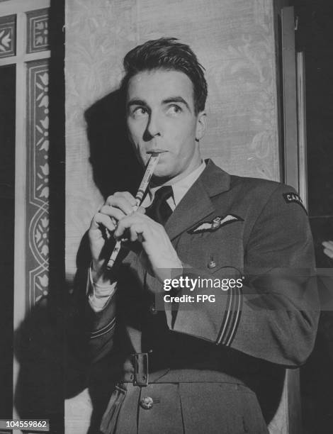 Montgomery Clift , American actor, pictured in uniform while playing a tin whistle, circa 1945.