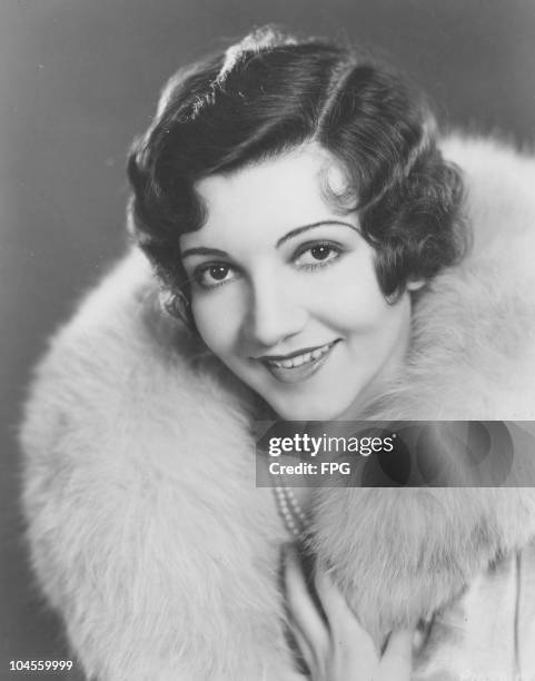 Claudette Colbert , French-born American stage and film actress, wearing a fur-collared coat, circa 1930.