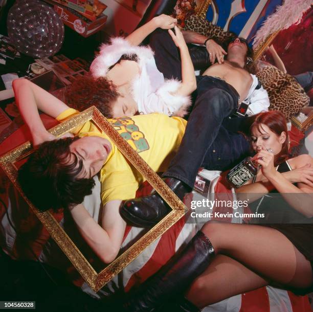 Guitarist Robert Young and singer Bobby Gillespie of Scottish rock group Primal Scream, pose with women friends in a scene of archetypal rock 'n'...