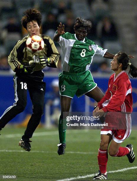 Goalkeeper Hong Gao of China leaps to catch the ball from Rita Nwadike of Nigeria during the Women's Group F Football Match during the Sydney 2000...