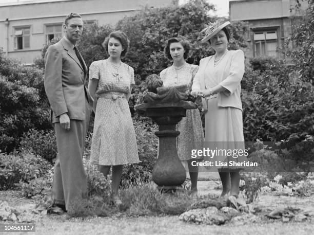 King George VI, the Queen Mother, Queen Elizabeth II and Princess Margaret in the gardens of Windsor Castle, England on July 8, 1946.