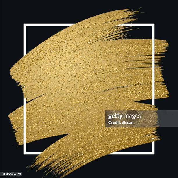 glitter golden brush stroke with frame on black background - brushing stock illustrations