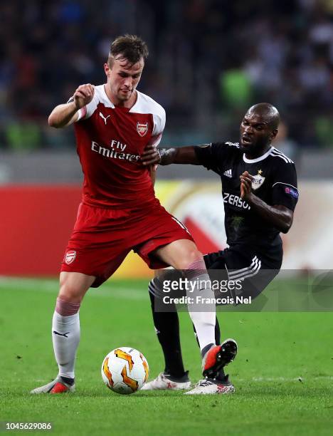 Innocent Emeghara of Qarabag battles for possession with Rob Holding of Arsenal during the UEFA Europa League Group E match between Qarabag FK and...
