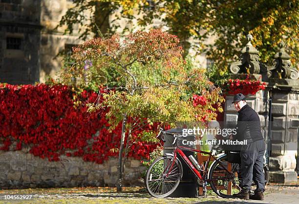 Cyclist enjoys a seat on a bench in the village of Falkland in Fife on September 2010 in Falkland, Scotland. The small Scottish village has won the...