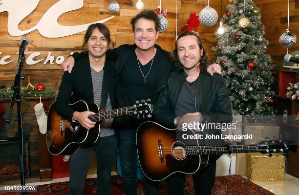 Luis Maldonado, Patrick Monahan and Jerry Becker of the Train visit Music Choice on October 4, 2018 in New York, United States.