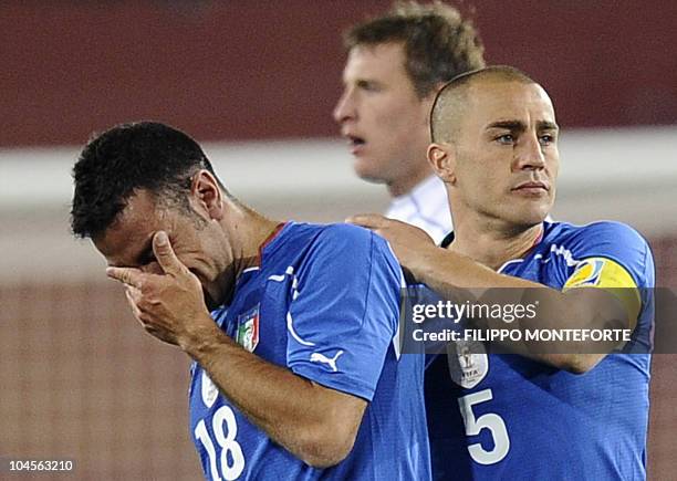 Italy's defender Fabio Cannavaro consoles Italy's striker Fabio Quagliarella after the Group F first round 2010 World Cup football match Italy versus...