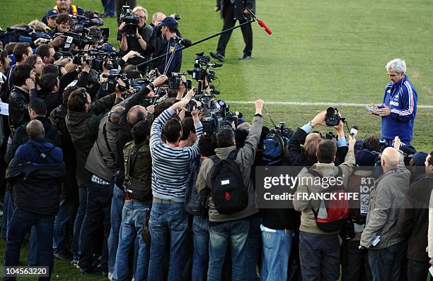 France's coach Raymond Domenech speaks in front of journalists during a team training session at the Fields of Dreams stadium in Knysna on June 20,...