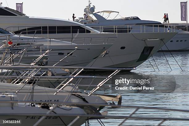 People pass in the background as luxury yachts float in the Puerto Banus harbour on September 29, 2010 in Marbella, Spain.