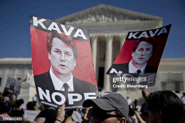 Protesters opposed to Supreme Court nominee Brett Kavanaugh hold "Kava Nope" signs while demonstrating outside the U.S. Supreme Court in Washington,...