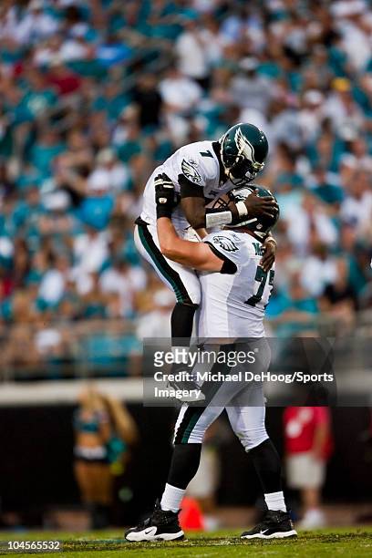 Quarterback Michael Vick of the Philadelphia Eagles celebrates with teammate Mike McGlynn during a NFL game against the Jacksonville Jaguars at...