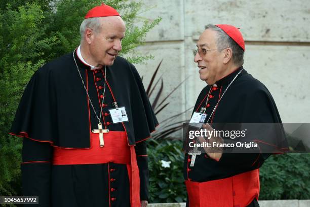 Archbishop of Wien cardinal Christoph Schonborn , chats with cardinal Oscar Rodrigo Maradiaga as they arrive at the Synod Hall for a session of the...