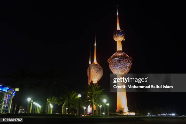 beautiful kuwait skyline with kuwait towers in frame at night along arabian gulf - kuwait landscape stock pictures, royalty-free photos & images