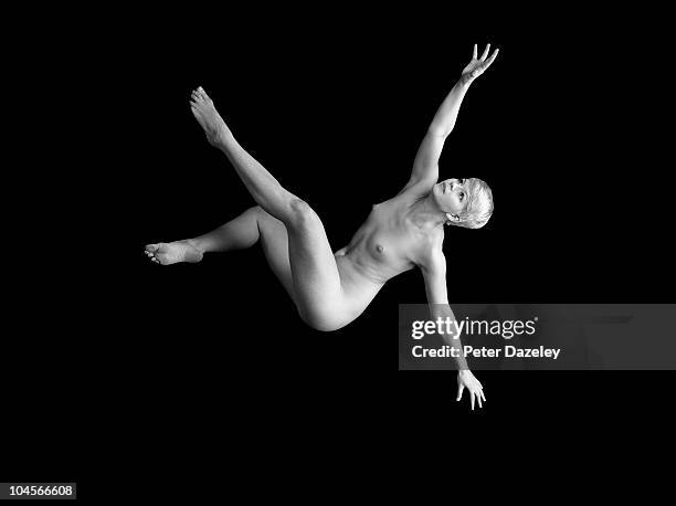 falling girl on black background - young women no clothes stock pictures, royalty-free photos & images