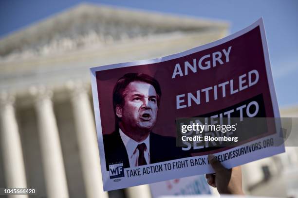 Protester opposed to Supreme Court nominee Brett Kavanaugh holds a sign outside the U.S. Supreme Court in Washington, D.C., U.S., on Thursday, Oct....