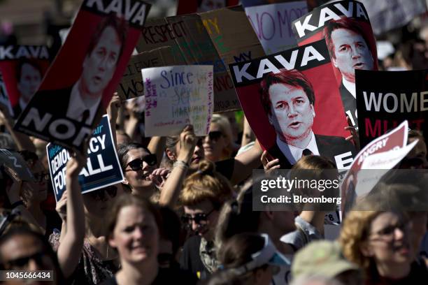 Protesters opposed to Supreme Court nominee Brett Kavanaugh hold "Kava Nope" signs while marching toward the U.S. Supreme Court in Washington, D.C.,...
