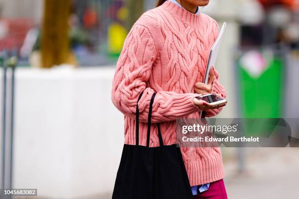 Guest wears a pink wool pullover, outside Chanel, during Paris Fashion Week Womenswear Spring/Summer 2019 on October 2, 2018 in Paris, France.