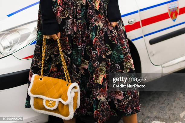 Guest is seen on the street during Paris Fashion Week SS19 wearing Chanel on October 2, 2018 in Paris, France.