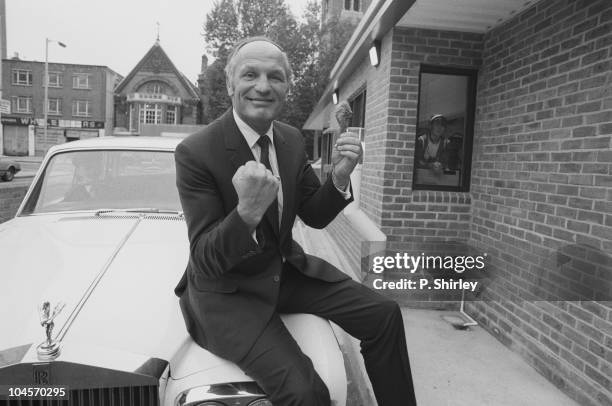 British ex-heavyweight boxer Henry Cooper sits on his Rolls Royce on November 01, 1983.