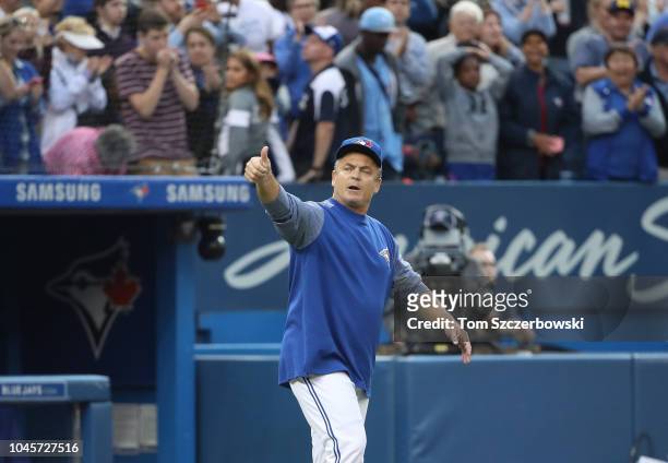 Manager John Gibbons of the Toronto Blue Jays comes out of the dugout and gives a thumbs-up after their victory and his final home game as manager...