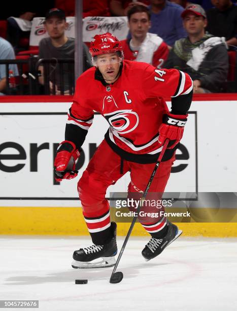 Newly named captain Justin Williams of the Carolina Hurricanes skates with the puck during an NHL game against the New York Islanders on October 4,...