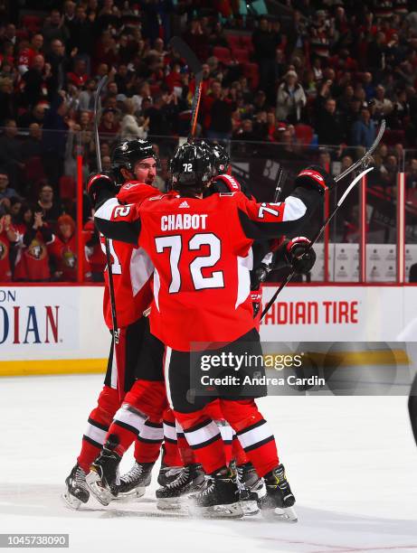 Mark Stone and Thomas Chabot of the Ottawa Senators celebrate after a first period goal scored by teammate Zack Smith against the Chicago Blackhawks...