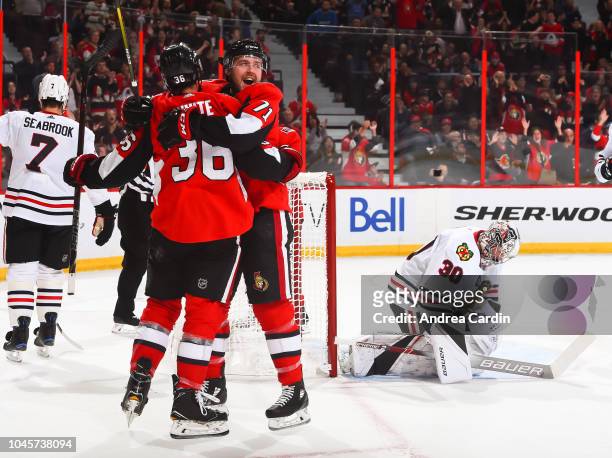 Colin White of the Ottawa Senators celebrates with teammate Mark Stone after scoring a first period goal on Cam Ward the Chicago Blackhawks at...