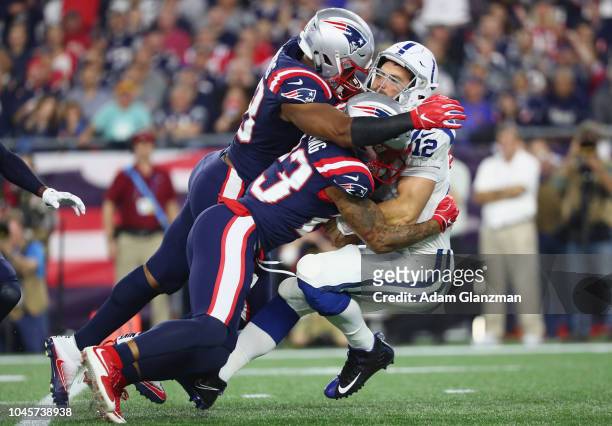 Andrew Luck of the Indianapolis Colts is sacked by Trey Flowers and Patrick Chung of the New England Patriots during the first half at Gillette...